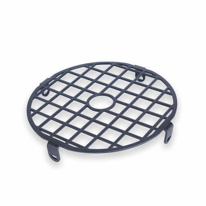 Angled view of a round matte black steel headlight grille with a square grid pattern, central ring, and four slotted mounting tabs.