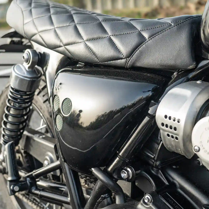 Compact glossy side panels on Triumph Bonneville T120 leaving part of the frame visible