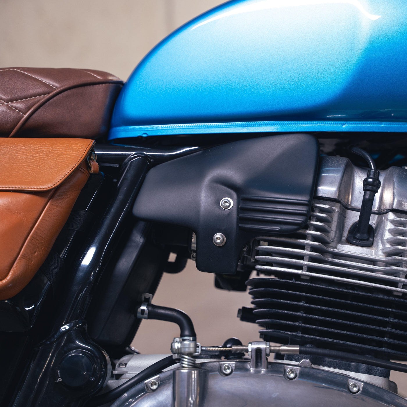 Bonvent heat shield air deflector installed under the tank on a blue Royal Enfield Interceptor 650
