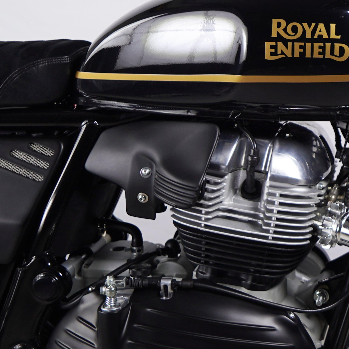 Matte black heat shield air deflector fitted on a black Royal Enfield Interceptor 650 with gold tank stripe