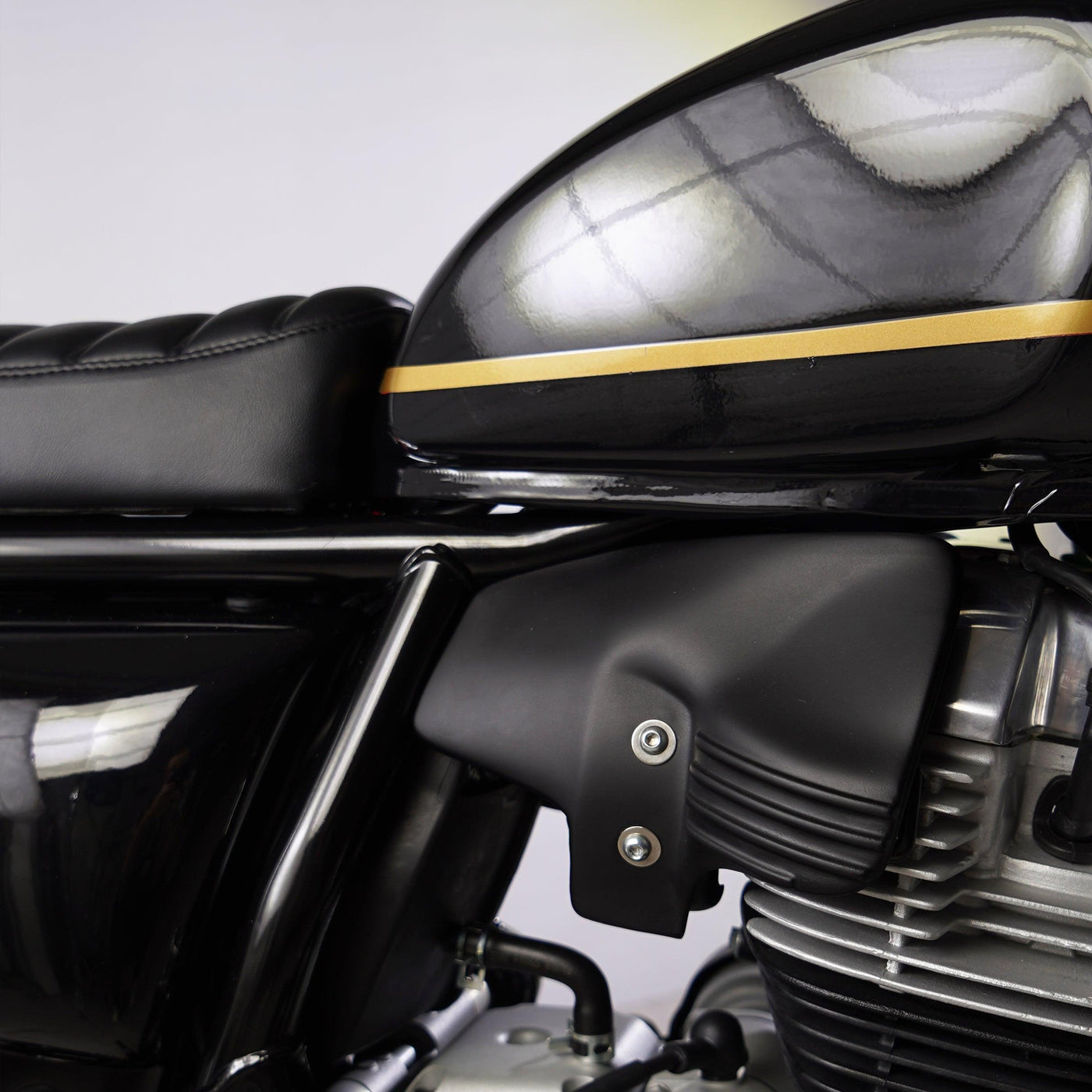 Detailed view of Bonvent heat shield air deflector fitted between the tank and engine on a Royal Enfield 650