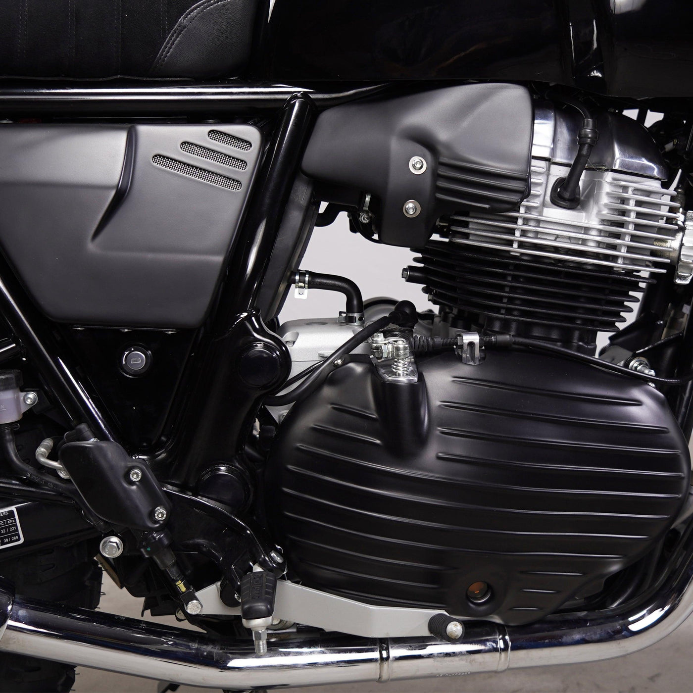 Close-up side view of Bonvent heat shield air deflector installed near the engine on a Royal Enfield 650