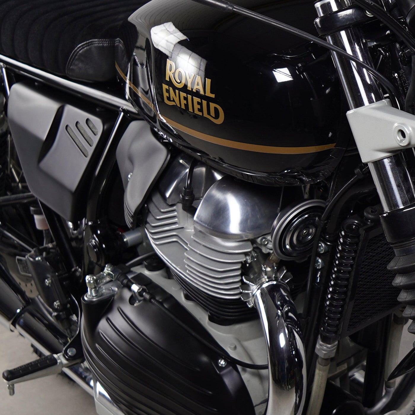 Close-up of Royal Enfield Interceptor 650 tank and engine with Bonvent matte black air deflector