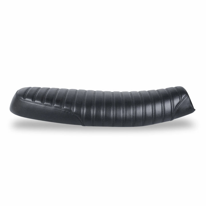 Side view of a low-profile black motorcycle seat with ribbed upholstery, curved stitching and tapered ends on a white background.
