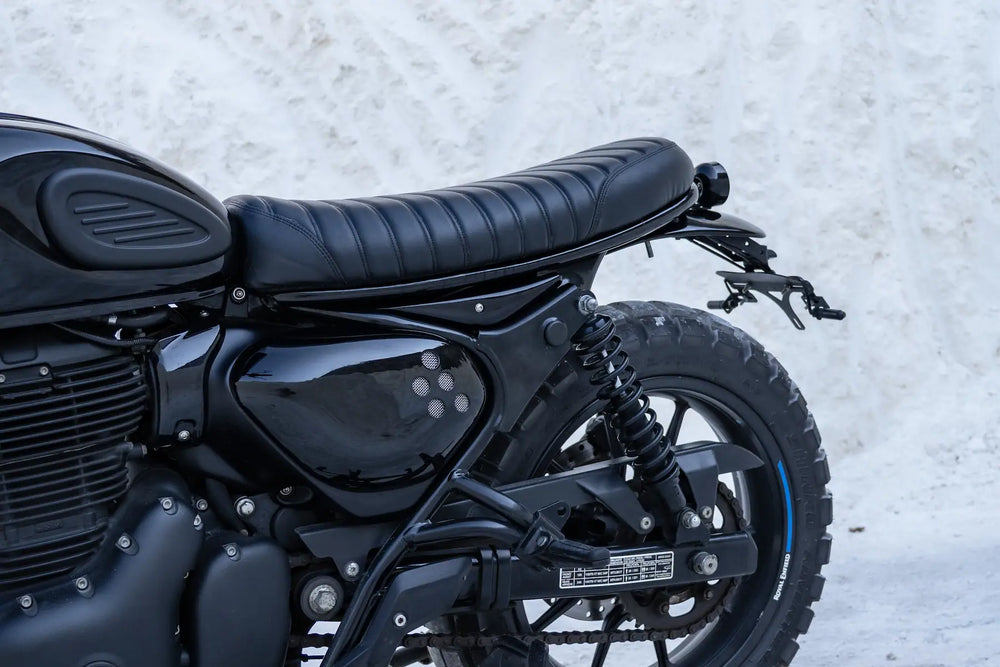 Rear side view of a Hunter 350 scrambler with bespoke high-mount twin-silencer exhaust