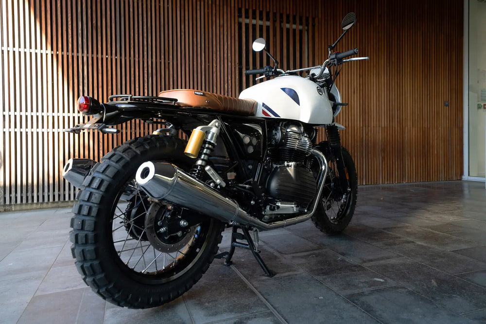 Rear three-quarter view of Royal Enfield Interceptor 650 Dakar build with modular seat and original exhausts