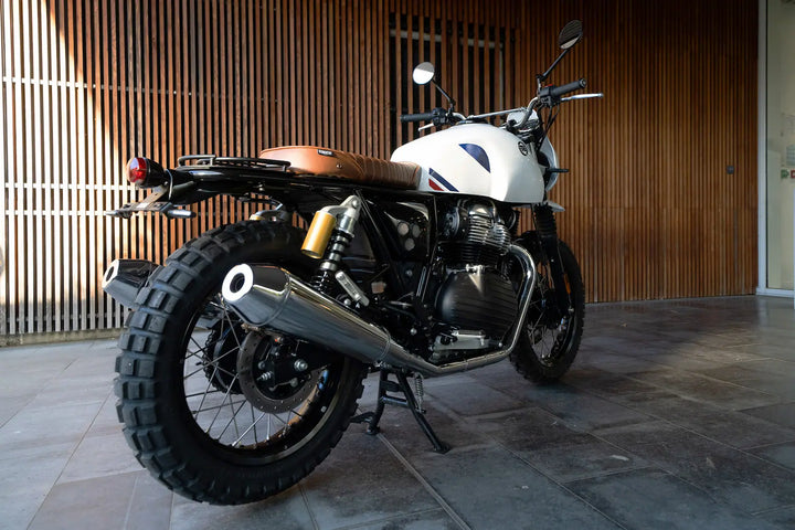 Rear three-quarter view of Royal Enfield Interceptor 650 Dakar build with modular seat and original exhausts