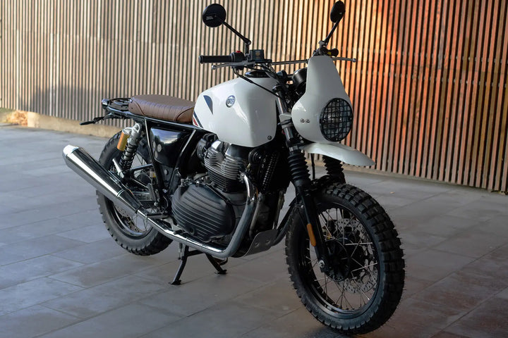 Front three-quarter view of Royal Enfield Interceptor 650 Dakar scrambler with tank cover and headlight cowl