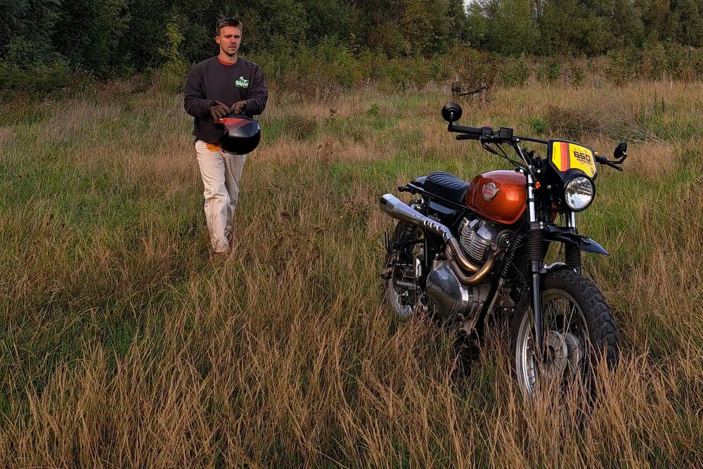 Rider with a Royal Enfield Interceptor 650 Orange Crush scrambler build
