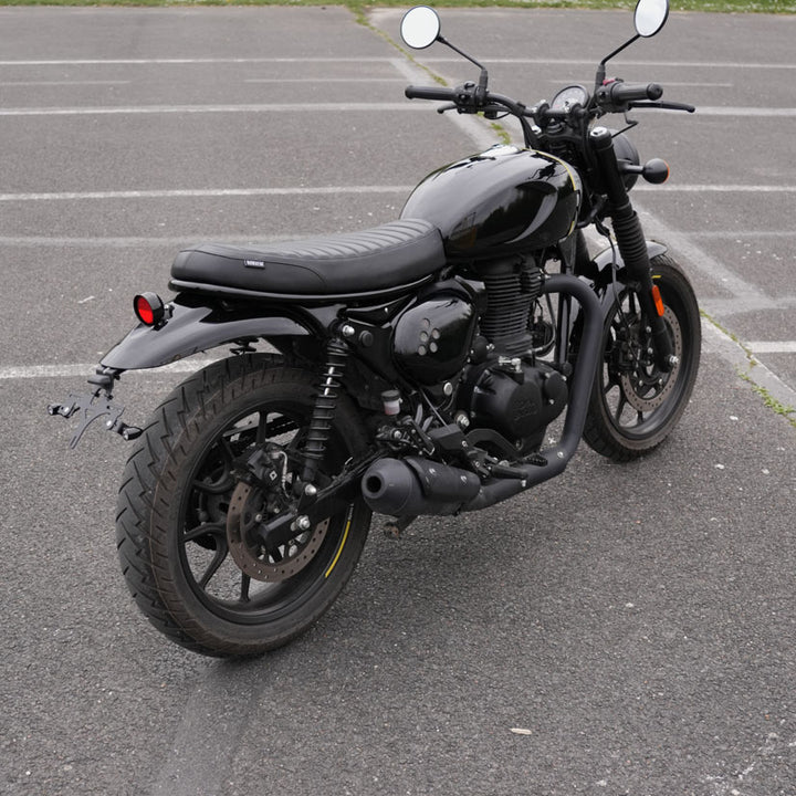 Modern black ribbed seat for Royal Enfield Hunter 350 with custom scrambler and cafe racer motorcycle styling