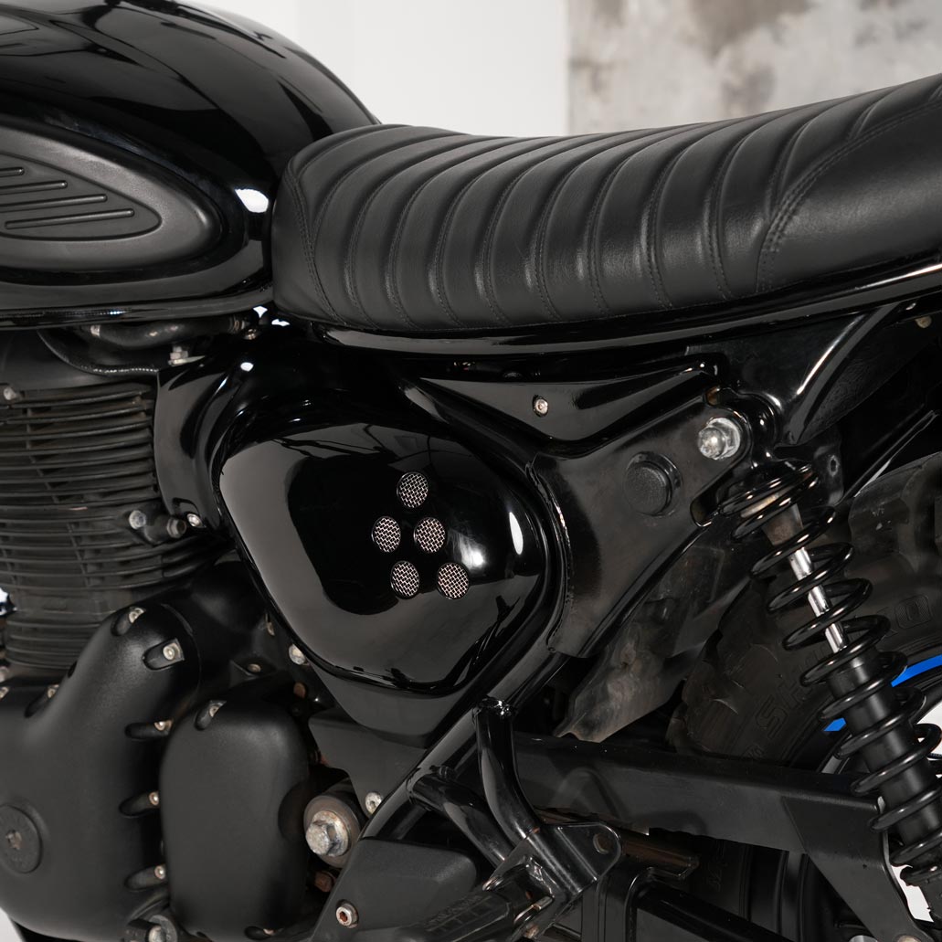Black custom side covers installed on Royal Enfield Hunter 350 scrambler build with vintage inspired side panels and vented motorcycle styling