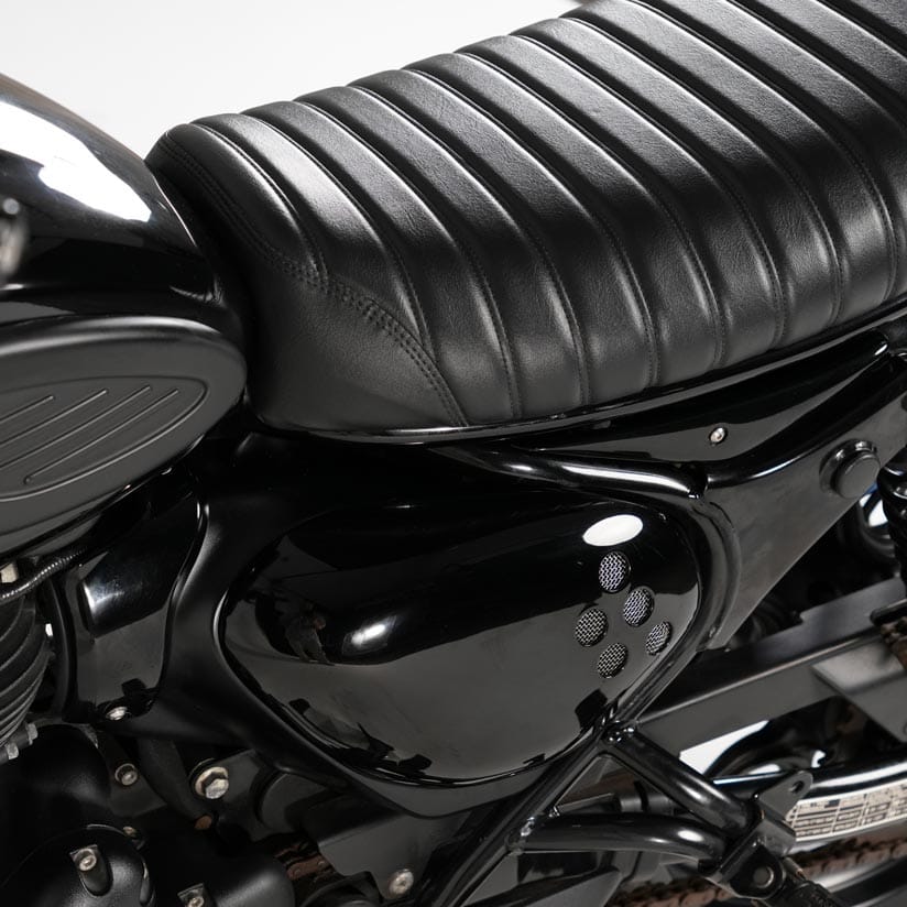 Close up detail of custom vented side cover for Royal Enfield Hunter 350 with rounded vintage motorcycle styling and scrambler inspired design