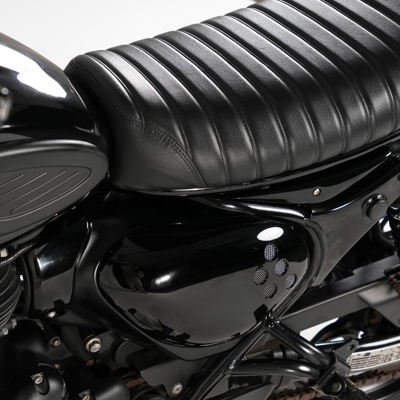 Close up detail of custom vented side cover for Royal Enfield Hunter 350 with rounded vintage motorcycle styling and scrambler inspired design