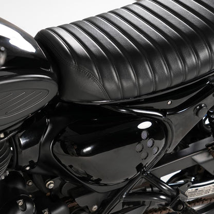 Close up detail of custom vented side cover for Royal Enfield Hunter 350 with rounded vintage motorcycle styling and scrambler inspired design