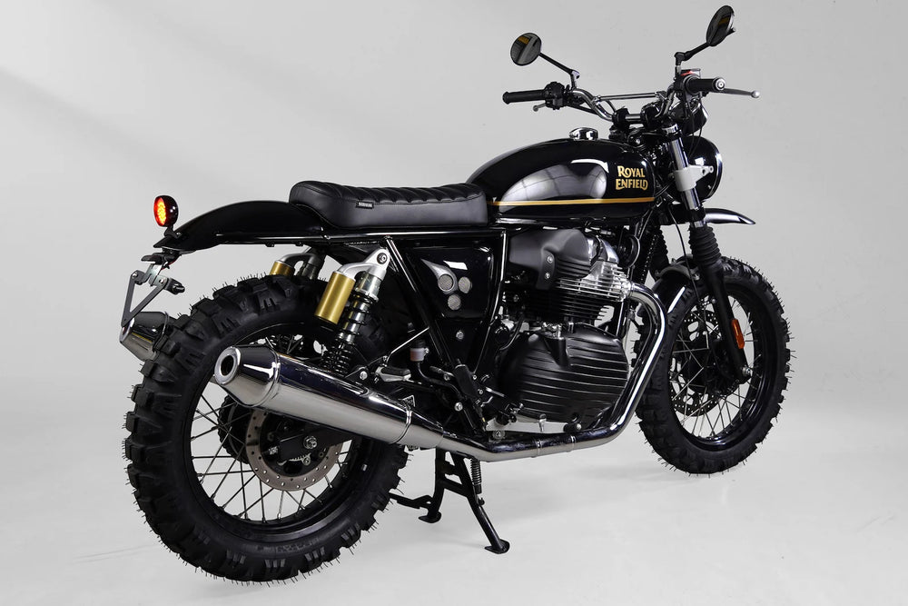 Rear three-quarter view of a black and gold Royal Enfield Interceptor 650 custom scrambler