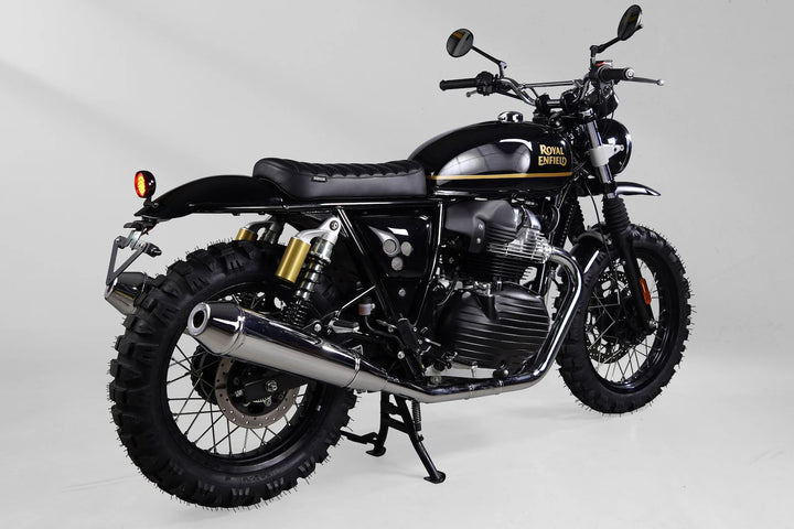 Rear three-quarter view of a black and gold Royal Enfield Interceptor 650 custom scrambler
