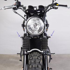Motorcycle turn signal brackets mounted under the fork on Royal Enfield 650