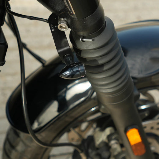 Discreet front indicator brackets mounted under the fork on a Triumph Bonneville T100/T120