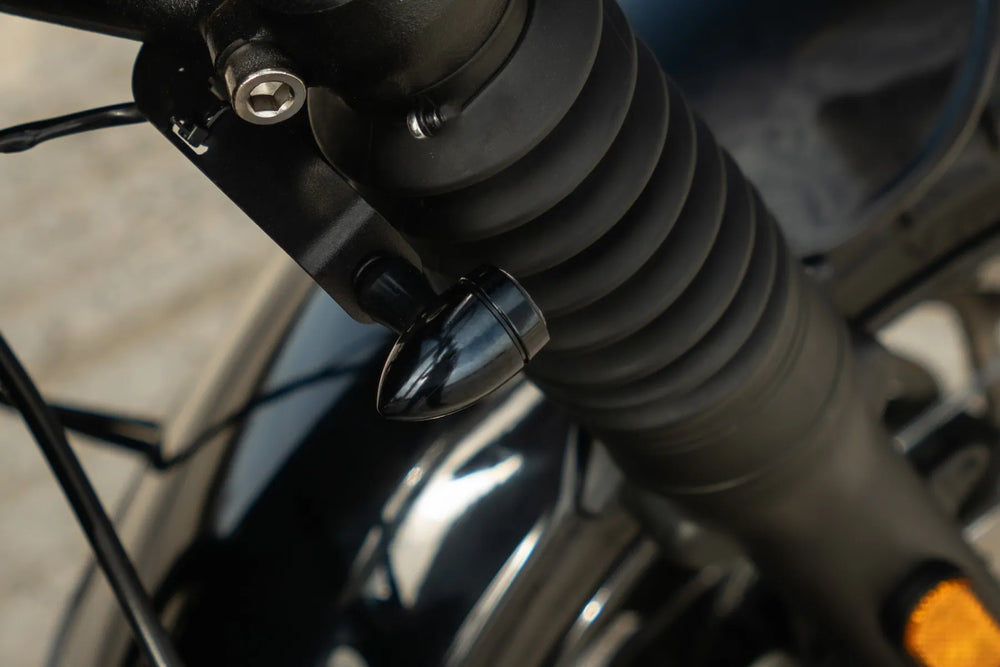 Bullet LED indicator mounted discreetly beneath the front fork of a Triumph Bonneville T120