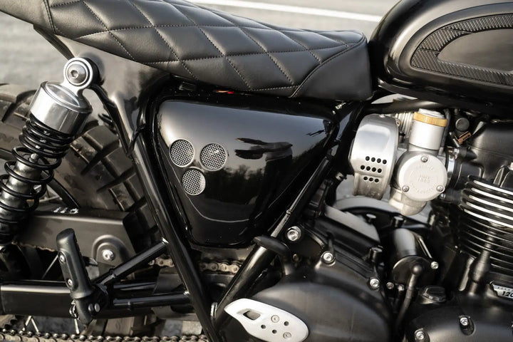 Compact Bonvent side cover revealing the frame of a black Triumph Bonneville T120