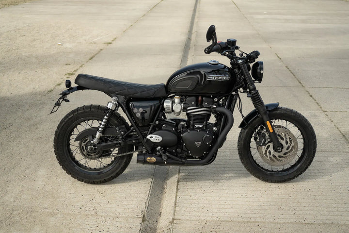 Rear three-quarter view of a Triumph Bonneville T120 custom build with a short rear fender and black Zard exhaust