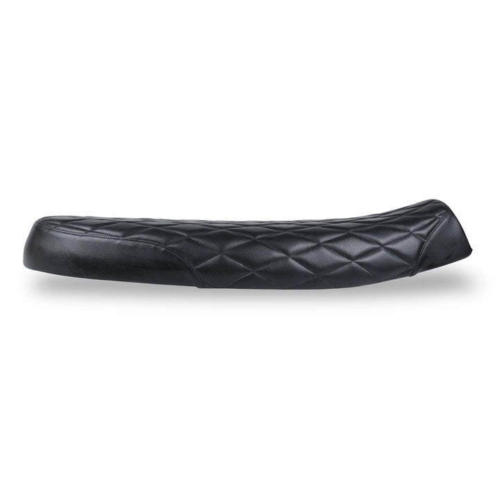Side view of a low-profile black motorcycle seat with diamond-quilted upholstery and a gently raised rear section.