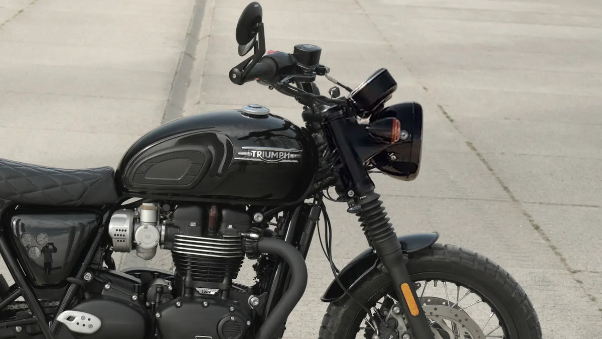 Stock Triumph Bonneville cockpit with OEM plastic twin-clock speedometer housing